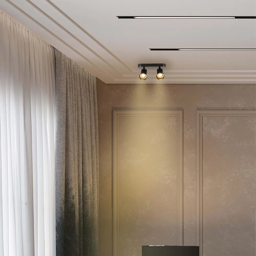 Foco cilíndrico moderno gris GU10 realzando una sala de estar elegante con decoración contemporánea e iluminación sofisticada.172-030392