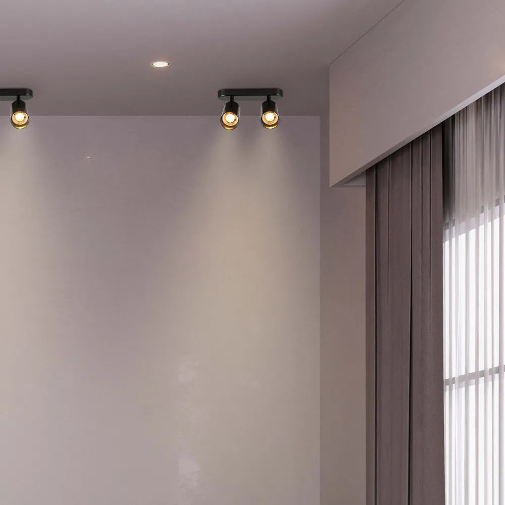 Foco cilíndrico elegante en color gris que ilumina un comedor moderno, realzando la decoración contemporánea con luz focalizada y diseño elegante.172-030392