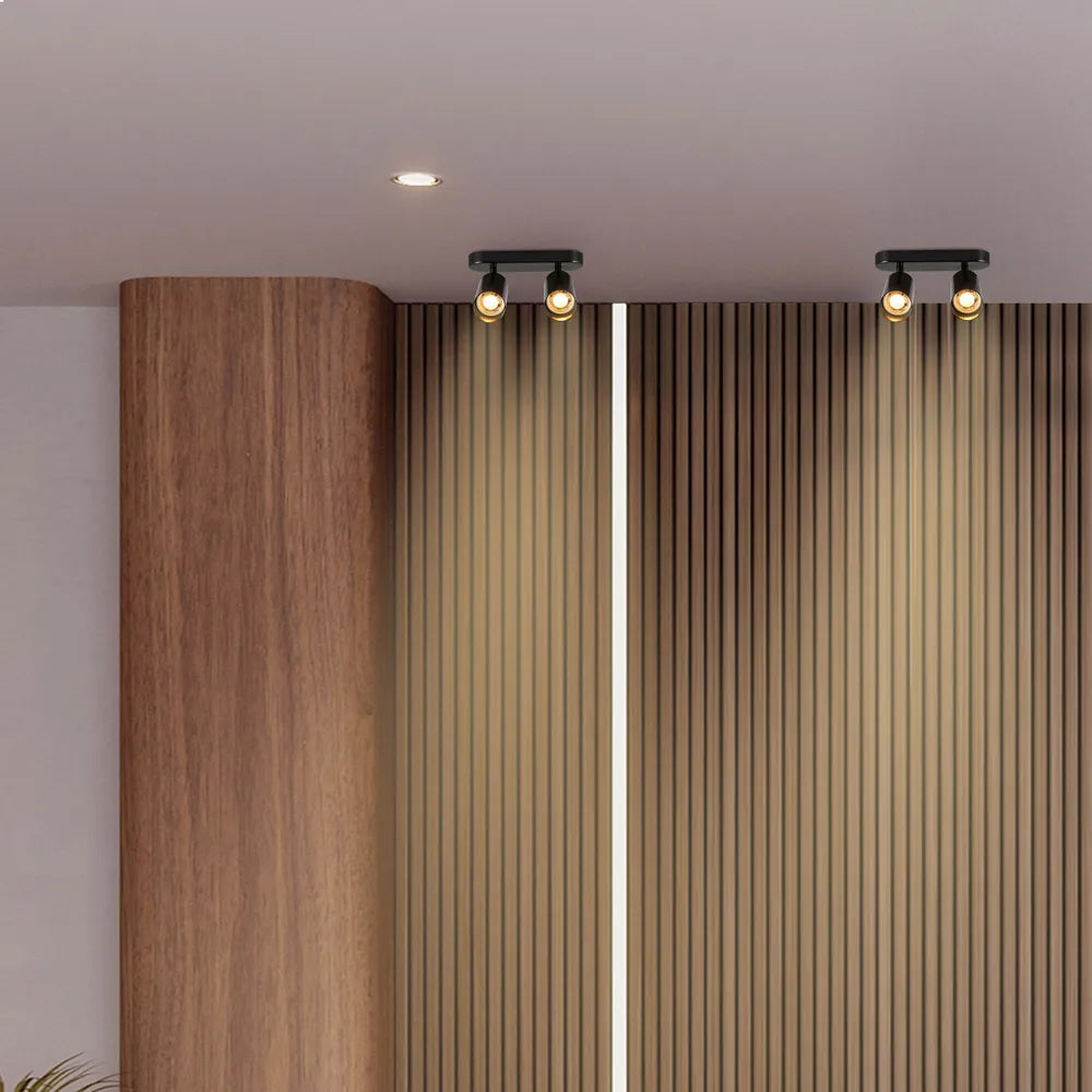 Foco cilíndrico moderno en gris perla iluminando una elegante sala de estar con decoración minimalista y ambiente suave y cálido. Perfecto para una iluminación con estilo. 172-030392