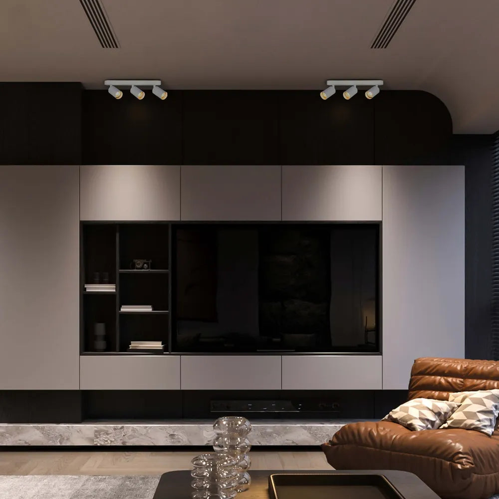 Foco cilíndrico moderno GU10 para haz de luz resaltando un área de comedor elegante con decoración contemporánea y ambiente cálido. 172-03055