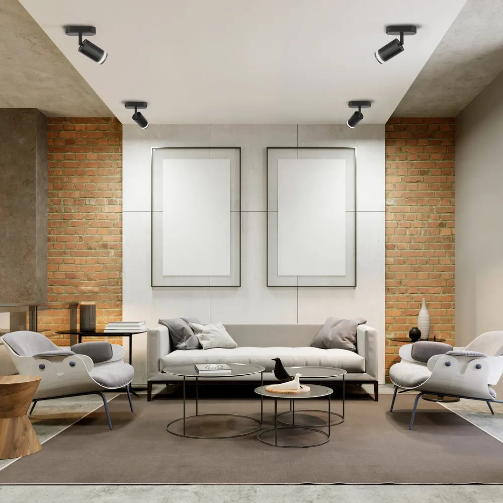 El accesorio de foco GU10 circular ilumina una sala de estar moderna con una decoración elegante, mejorando el ambiente y el estilo del espacio.172-03029