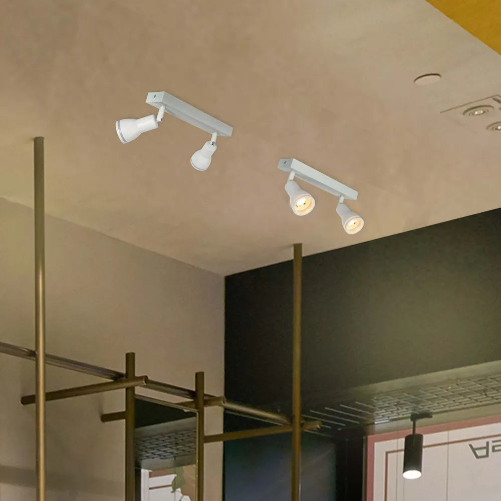 Foco moderno Luma Cylindro GU10 iluminando una sala de estar elegante con decoración contemporánea y ambiente acogedor.172-03218