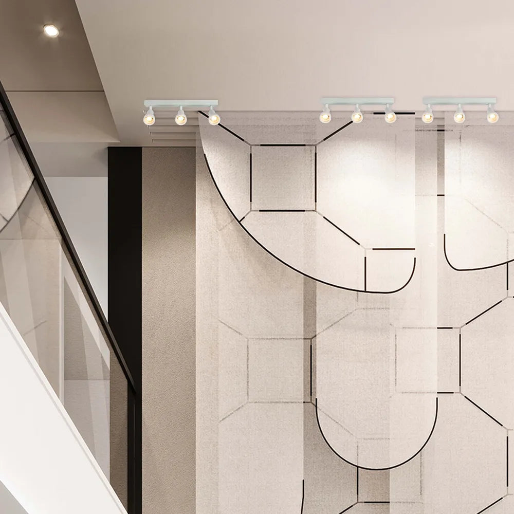 Aparato de iluminación Sleek Luma Cylindro GU10, iluminando una sala de estar moderna, realzando la decoración minimalista con acentos cálidos. 172-03220
