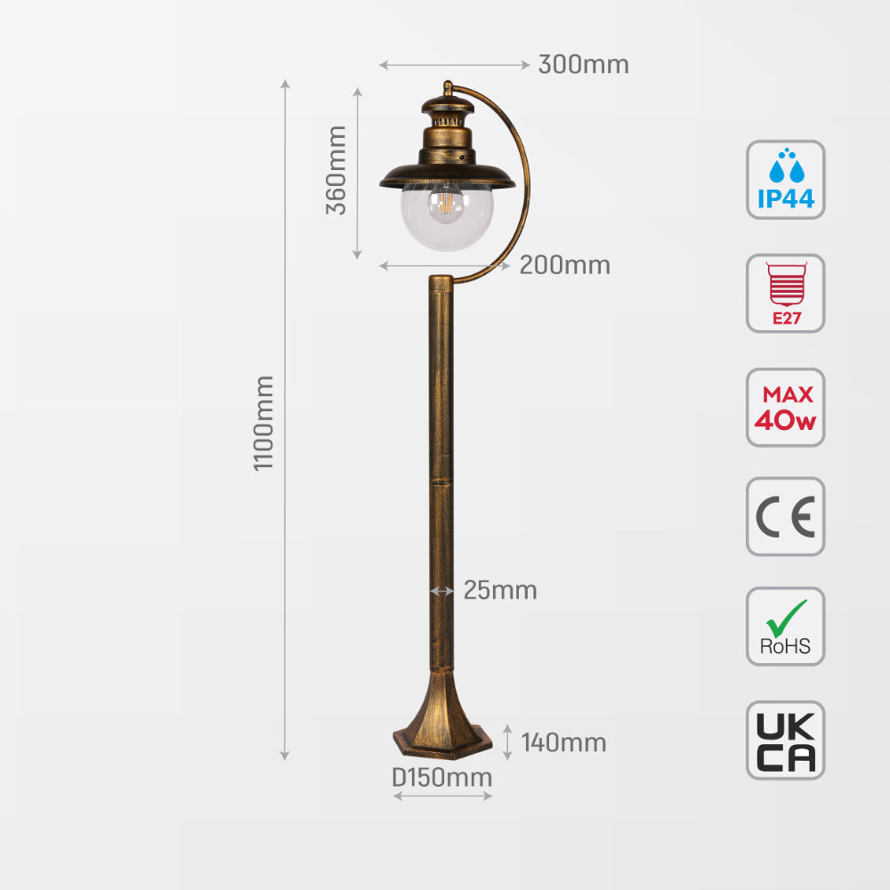 Luz de bolardo exterior negra con detalles dorados, ideal para senderos en jardines de estilo contemporáneo y moderno.