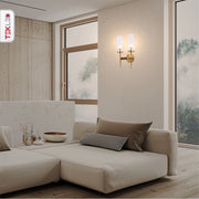 Gold Aluminium Bronze Cylinder Clear Glass Wall Light with 2xE14 Fitting in indoor setting living room