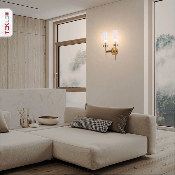 Gold Aluminium Bronze Cylinder Clear Glass Wall Light with 2xE14 Fitting in indoor setting living room