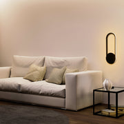 Aplique de pared LED en forma de elipse, ideal para espacios modernos, brindando luz ambiental en salas o pasillos elegantes.