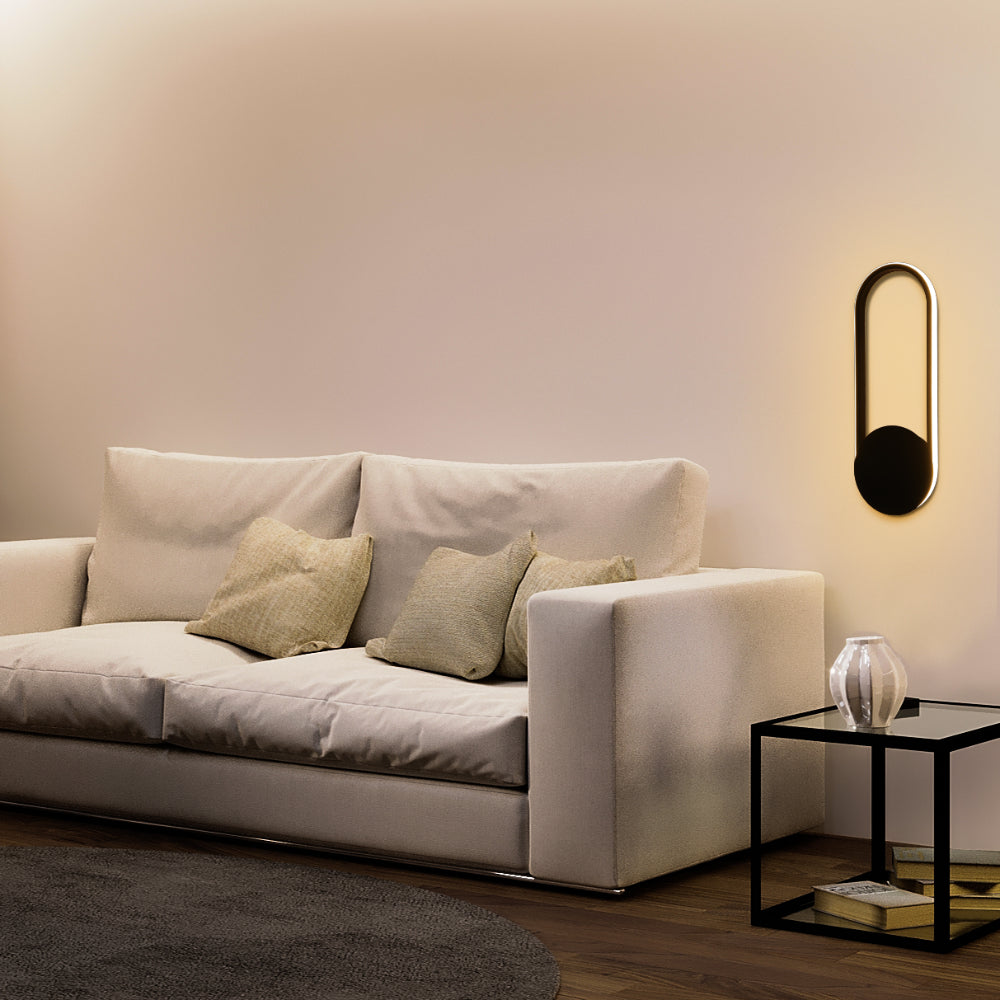 Aplique de pared LED en forma de elipse, ideal para espacios modernos, brindando luz ambiental en salas o pasillos elegantes.