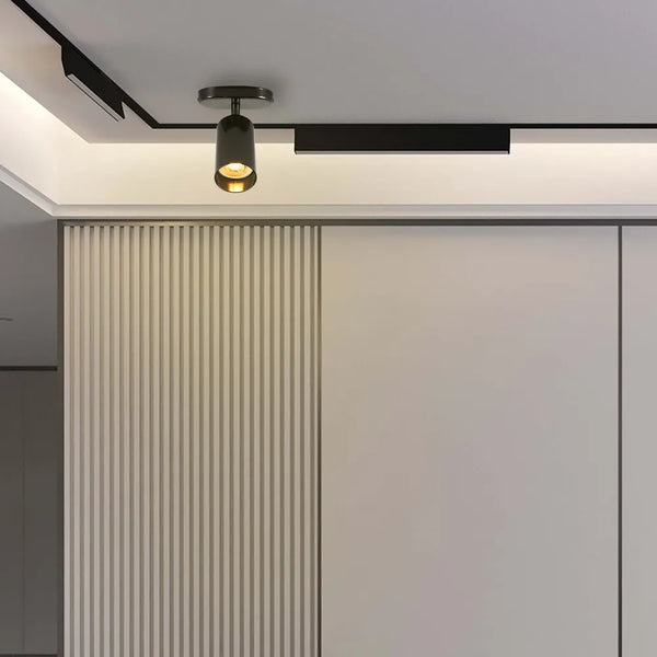 Foco GU10 en gris perla moderno iluminando elegantemente una sala de estar contemporánea con decoración minimalista y ambiente cálido.172-030391