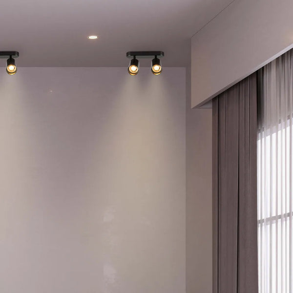 Foco cilíndrico elegante en color gris que ilumina un comedor moderno, realzando la decoración contemporánea con luz focalizada y diseño elegante.172-030392