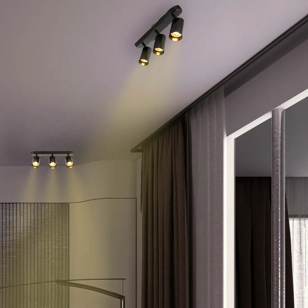 Astra Pearl Grey Cilindro GU10 Foco iluminando una sala de estar moderna con decoración minimalista, mejorando el ambiente elegante.172-030393