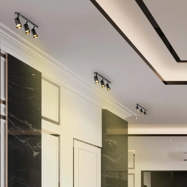 Foco cilíndrico moderno gris GU10 iluminando una sala de estar elegante, mejorando una decoración minimalista con iluminación suave y ambiental.172-030393