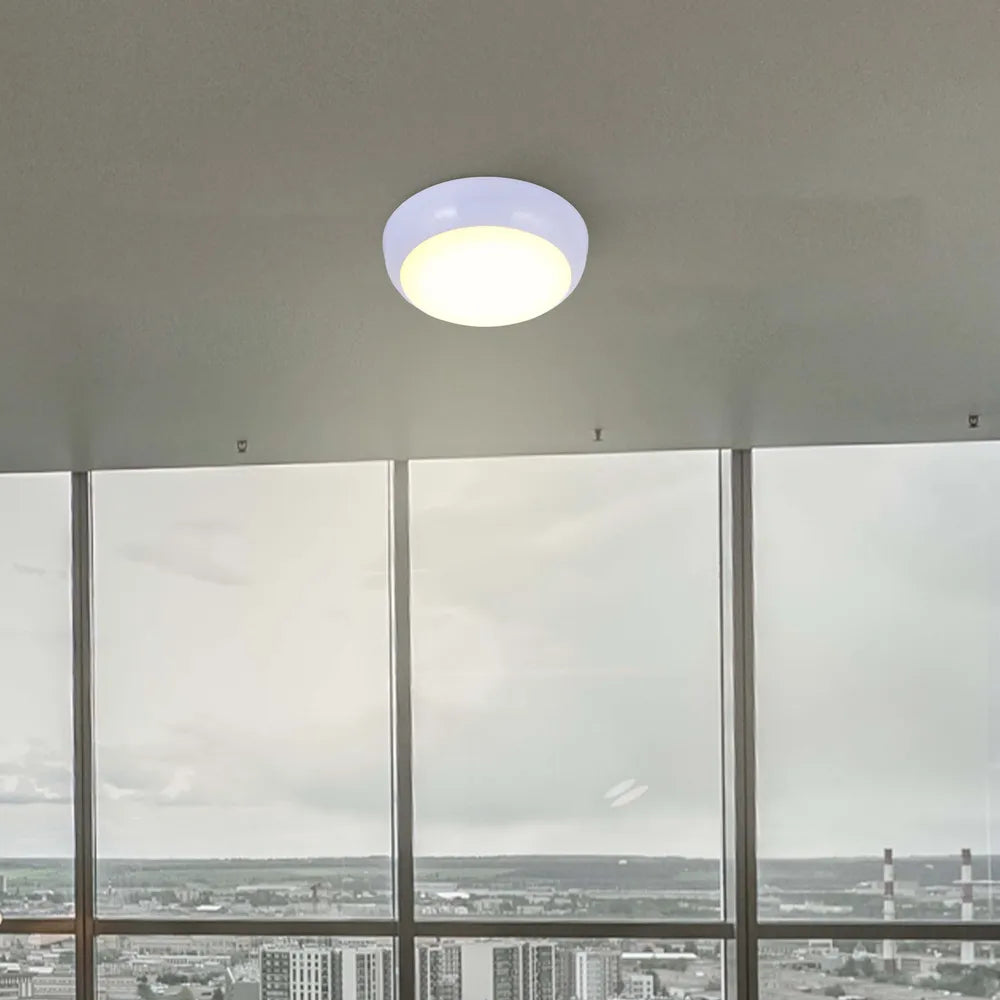 Luz de techo LED empotrada en un pasillo moderno, con un elegante borde blanco y opciones de temperatura de color versátiles para una decoración contemporánea.118-03616