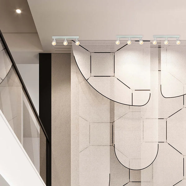 Aparato de iluminación Sleek Luma Cylindro GU10, iluminando una sala de estar moderna, realzando la decoración minimalista con acentos cálidos. 172-03220