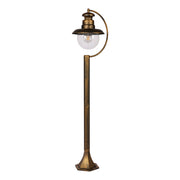 Luz de bolardo de jardín negra con detalles dorados, ideal para iluminar senderos en espacios exteriores con estilo moderno.
