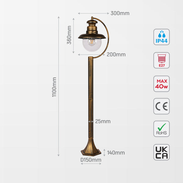 Luz de bolardo exterior negra con detalles dorados, ideal para senderos en jardines de estilo contemporáneo y moderno.