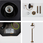 Luz de camino exterior tipo bolardo negra con detalles dorados, ideal para jardines y entradas con estilo moderno.