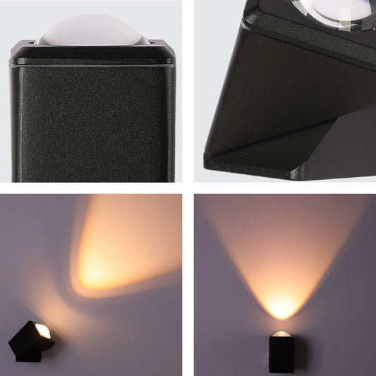 Primer plano de un aplique de pared LED negro rotatable, ideal para exteriores modernos, con luz de haz estrecho de 3000K.
