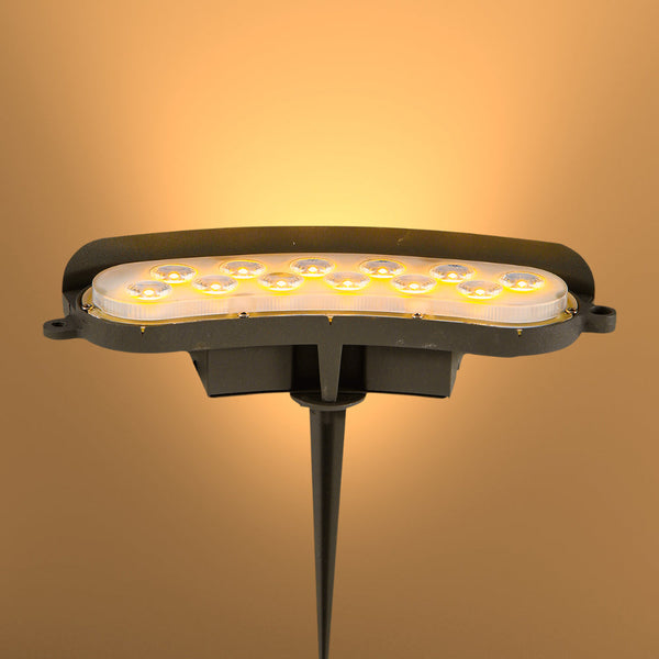 Foco LED de 12W, ideal para jardines modernos, proporcionando luz cálida o verde, perfecto para resaltar paisajes nocturnos.