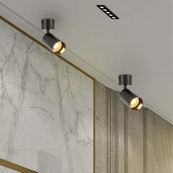 Elegante foco empotrado de superficie GU10 giratorio que ilumina una sala de estar moderna con una decoración elegante y acentos vibrantes.172-030282