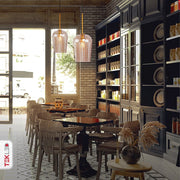 Amber glass schoolhouse pendant light with e27 fitting in indoor setting caf√© table tops